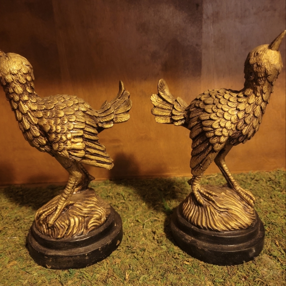 Two antique gold tone bird statuettes on bases. No brand on bottom.